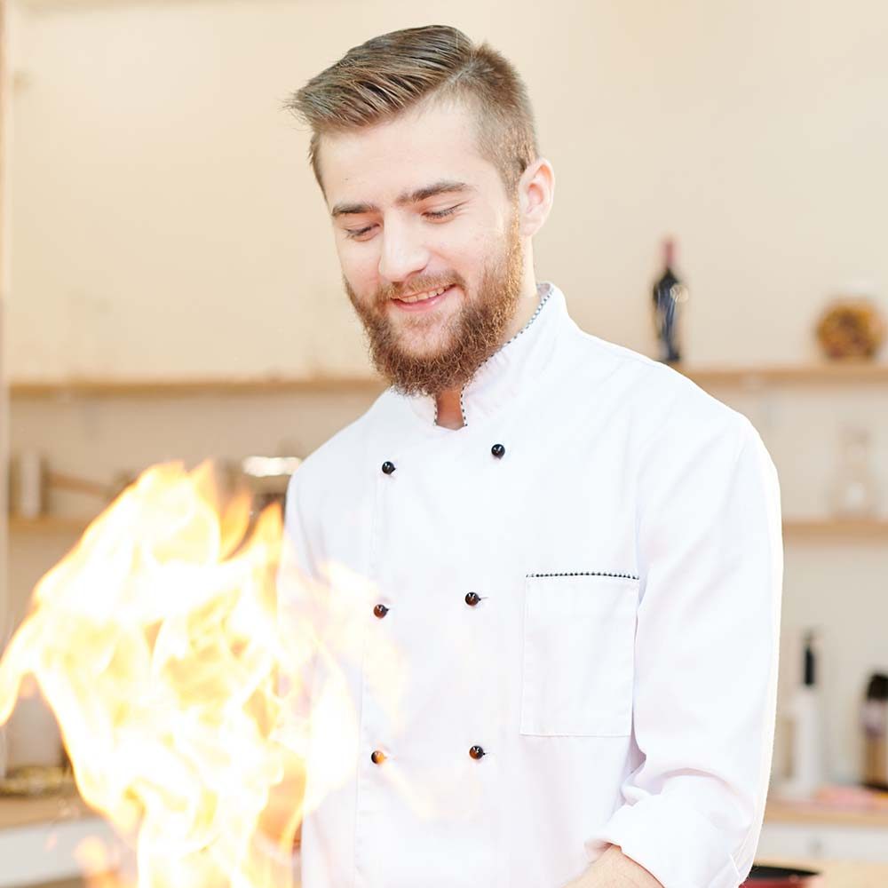 smiling-chef-cooking-flambe-PZSV6KL.jpg